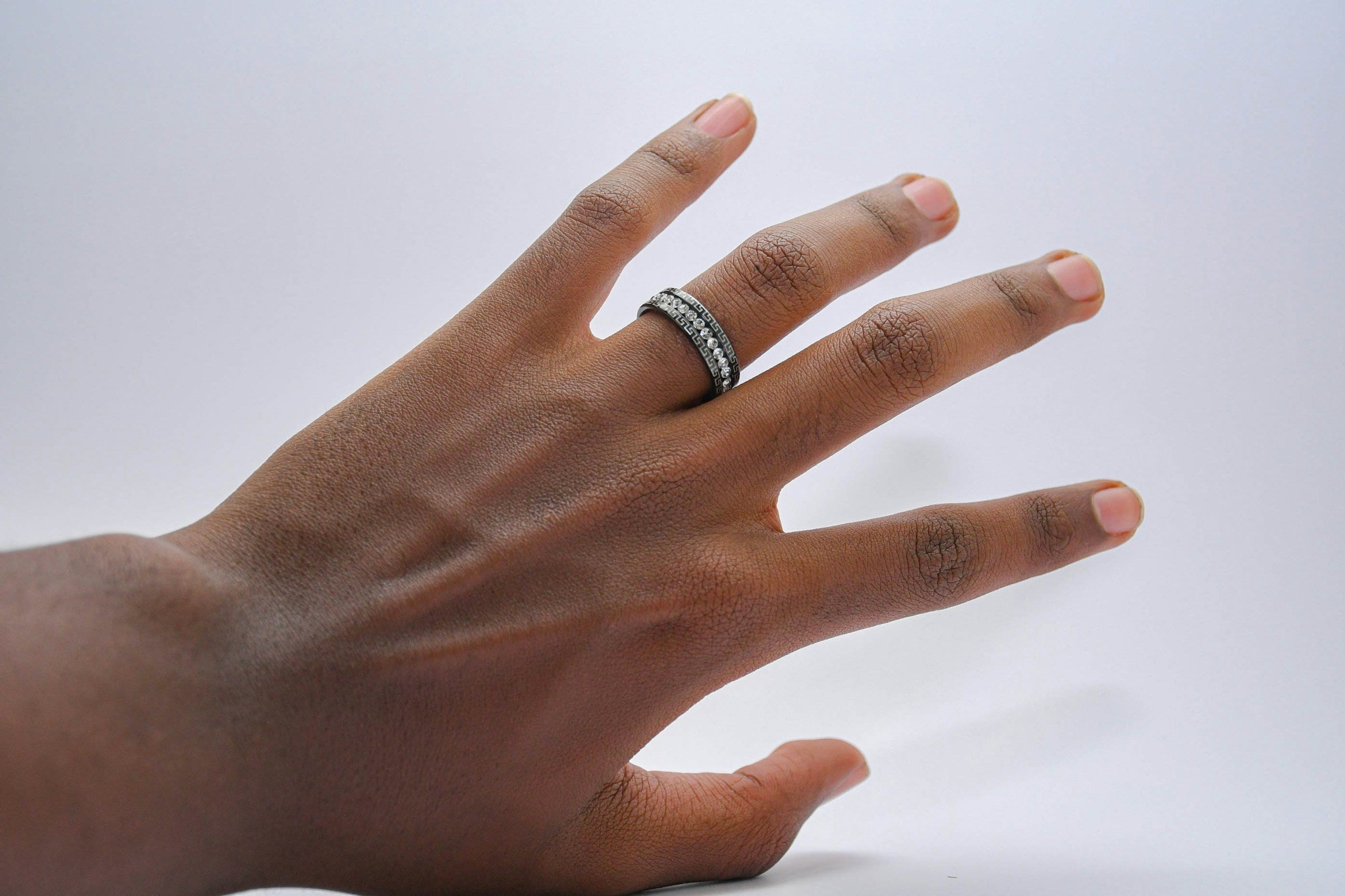 Hand wearing a sparkling band ring